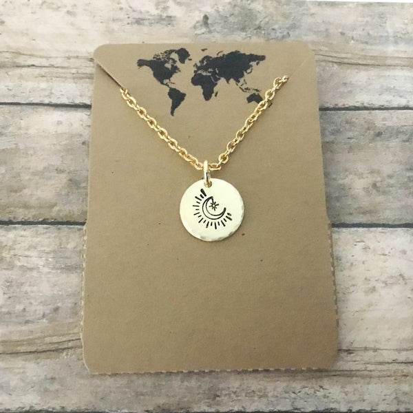 Small circular crescent moon charm necklace in gold tone